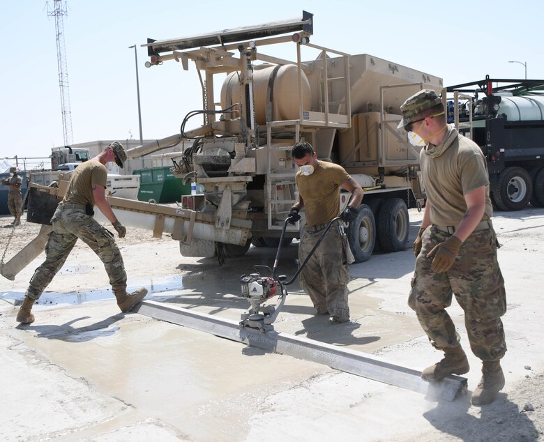 Airmen from the 380th Civil Engineer Squadron repair a hole in a simulation of flightline damage during a defense exercise, Sept. 24, 2020, at Al Dhafra Air Base, United Arab Emirates.
