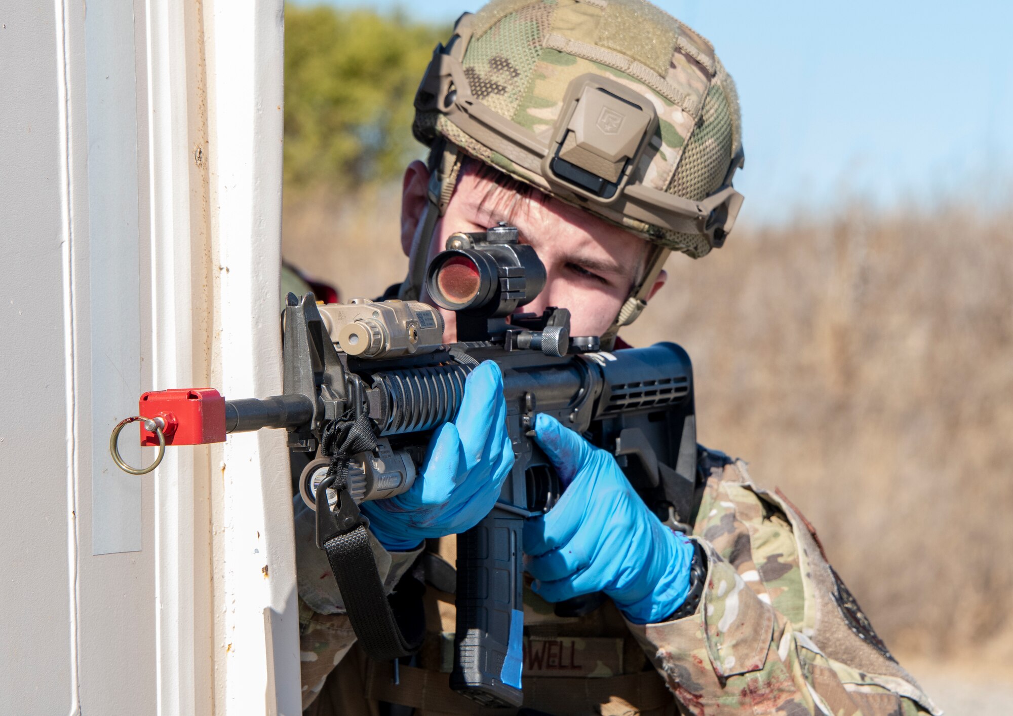 U.S. Air Force Airman 1st Class Blake Crowell, 60th Security Forces Squadron installation patrolman, assumes a defensive position during a base exercise Sept. 24, 2020, at Travis Air Force Base, California. The exercise was designed to evaluate the training, readiness and capability of Travis first responders in order to effectively respond to active shooter threats to the installation. (U.S. Air Force photo by Heide Couch)