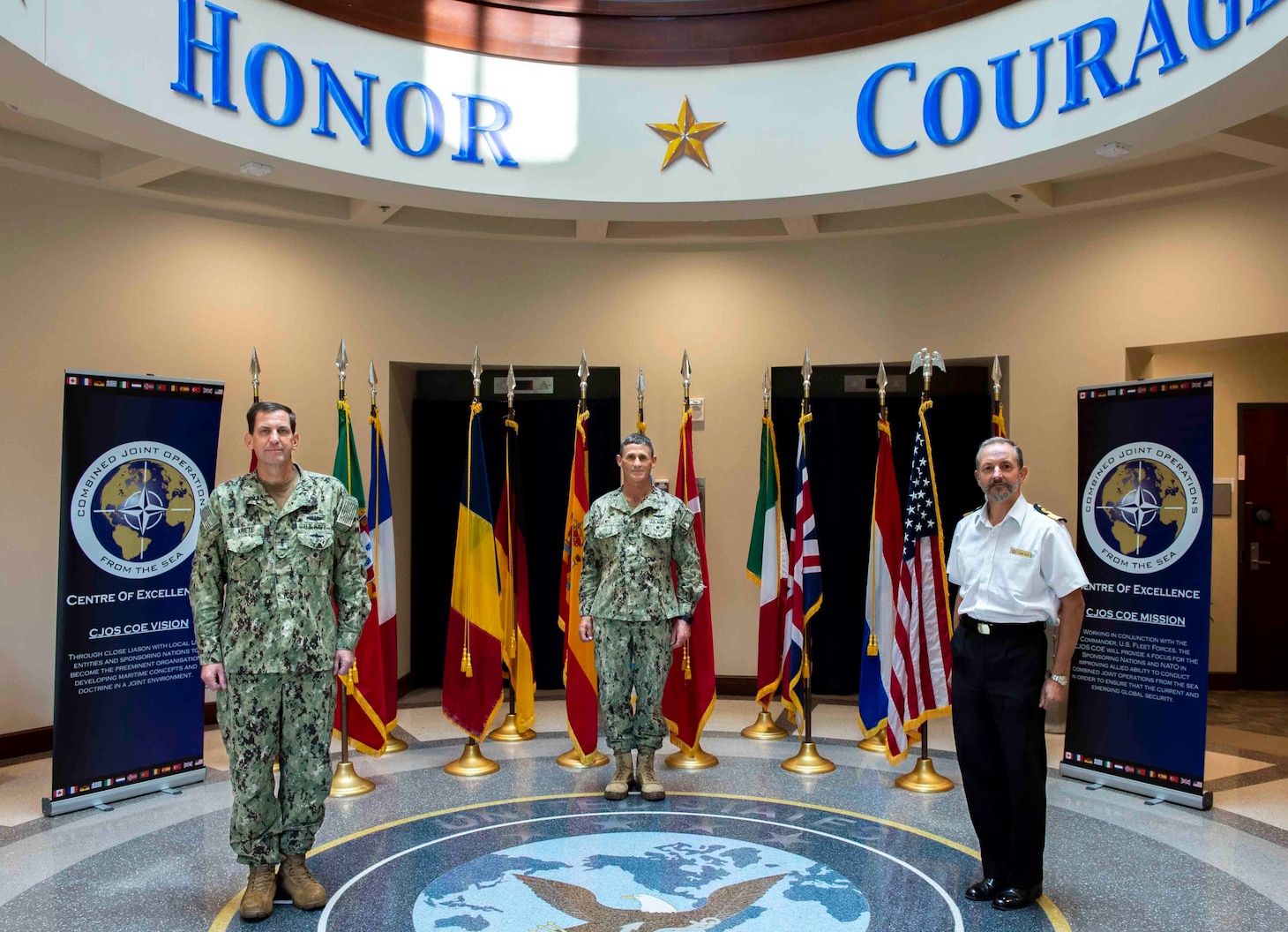 Vice Adm. Dave Kriete, outgoing director, Combined Joint Operations from the Sea Center of Excellence (CJOS COE), left, Vice Adm. Andrew Lewis, oncoming director, CJOS COE, center, and Royal Navy Commodore Thomas Guy, deputy director CJOS COE, participated in a ceremonial photograph in support of the transition of directorship from deputy commander, U.S. Fleet Forces Command to Commander, U.S. 2nd Fleet.