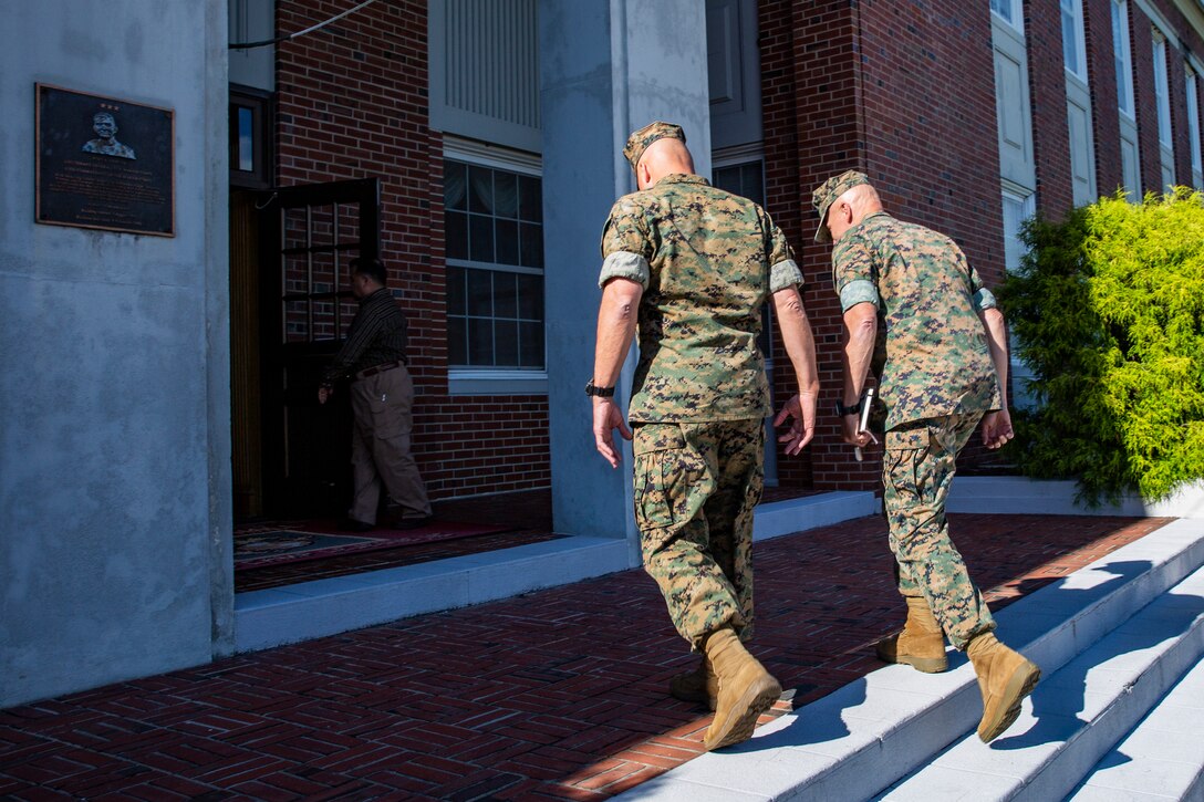 U.S. Marine Corps Maj. Gen. Julian D. Alford, left, commanding general, Marine Corps Installations East-Marine Corps Base Camp Lejeune, escorts Lt. Gen. Charles G. Chiarotti, right, deputy commandant, Installations and Logistics, into Bldg. 1 during his visit to MCB Camp Lejeune, North Carolina, Sept. 30, 2020. Chiarotti and Maj. Gen. Edward D. Banta, commander, Marine Corps Installations Command visited Camp Lejeune and other MCIEAST installations in Eastern North Carolina to receive updates on the progress of hurricane-related construction projects and repairs. (U.S. Marine Corps photo by LCpl. Christian Ayers)