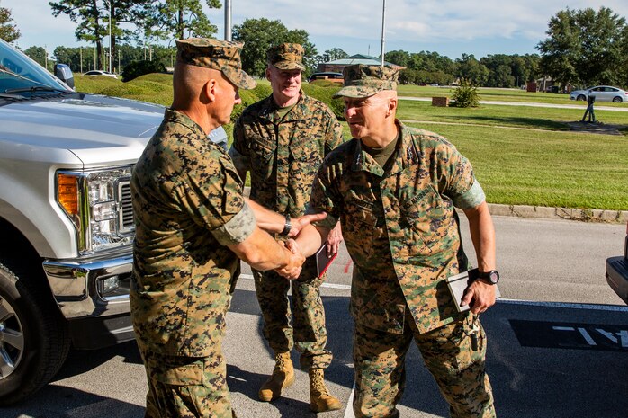 U.S. Marine Corps Lt. Gen. Charles G. Chiarotti, right, deputy commandant, Installations and Logistics, and Major General Edward D. Banta, center, commander, Marine Corps Installations Command are greeted by Maj. Gen. Julian D. Alford, left, commanding general, Marine Corps Installations East-Marine Corps Base Camp Lejeune, during their visit to MCB Camp Lejeune, North Carolina, Sept. 30, 2020. Chiarotti and Banta visited Camp Lejeune and other installations in Eastern North Carolina to receive updates on the progress of hurricane-related construction and repair projects. (U.S. Marine Corps photo by LCpl. Christian Ayers)