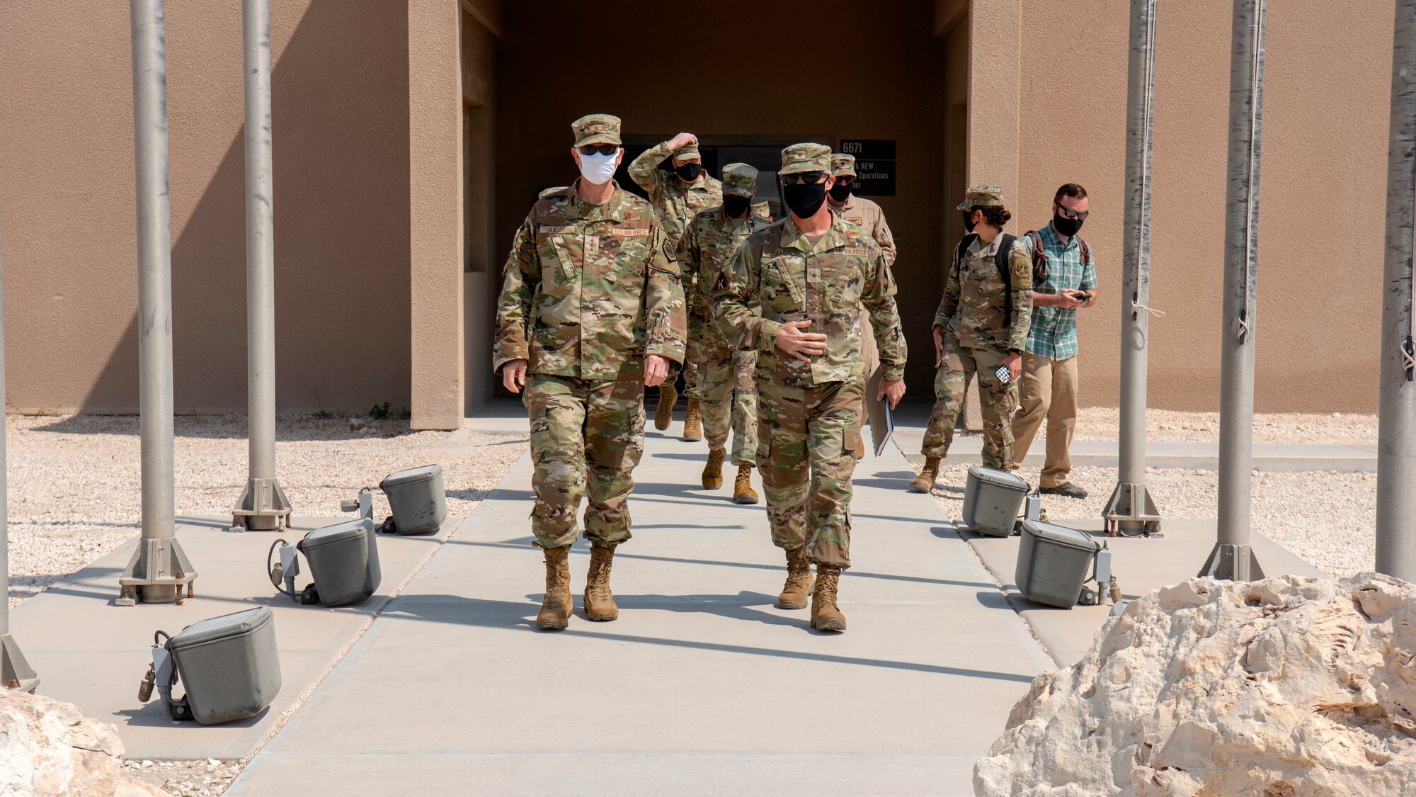U.S. Air Force Lt. Gen. Greg Guillot, U.S. Air Forces Central commander, walks with Brig. Gen. Daniel Tulley, 379th Air Expeditionary Wing commander, during his troop engagement with the 379th AEW at Al Udeid Air Base, Qatar, Sept. 28, 2020. During his visit, Guillot briefed his expectations for the 379th AEW, as well as the expectations his Airmen should have of him.
