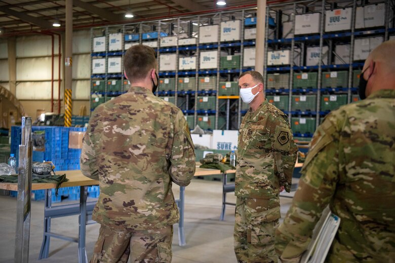 U.S. Air Force 1st Lt. William Heinzel, 379th Expeditionary Civil Engineer Squadron operations engineering officer in charge, briefs U.S. Air Force Lt. Gen. Greg Guillot, U.S. Air Forces Central commander, on unit improvements during his troop engagement at Al Udeid Air Base, Qatar, Sept. 28, 2020. During his visit, Guillot interacted with Airmen and recognized outstanding performers in support of the wing and operations across the region.