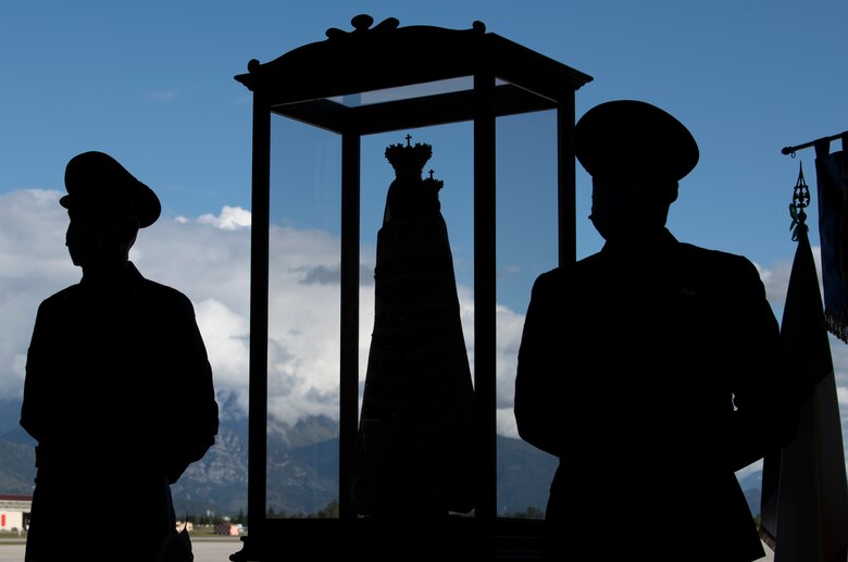 Two Italian air force members stand guard by a Madonna Di Loreto statue at Aviano Air Base, Italy, Sept. 27, 2020. The Madonna Di Loreto is the Patroness of Aeronauts, as declared by Pope Benedict XV. (U.S. Air Force photo by Senior Airman Caleb House)