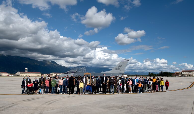 Attendees pose for a group photo with the Madonna Di Loreto statue at Aviano Air Base, Italy, Sept. 27, 2020. The statue is on a pilgrimage around Italy in celebration of the centenary of her proclamation as the Patroness of Aeronauts. (U.S. Air Force photo by Senior Airman Caleb House)