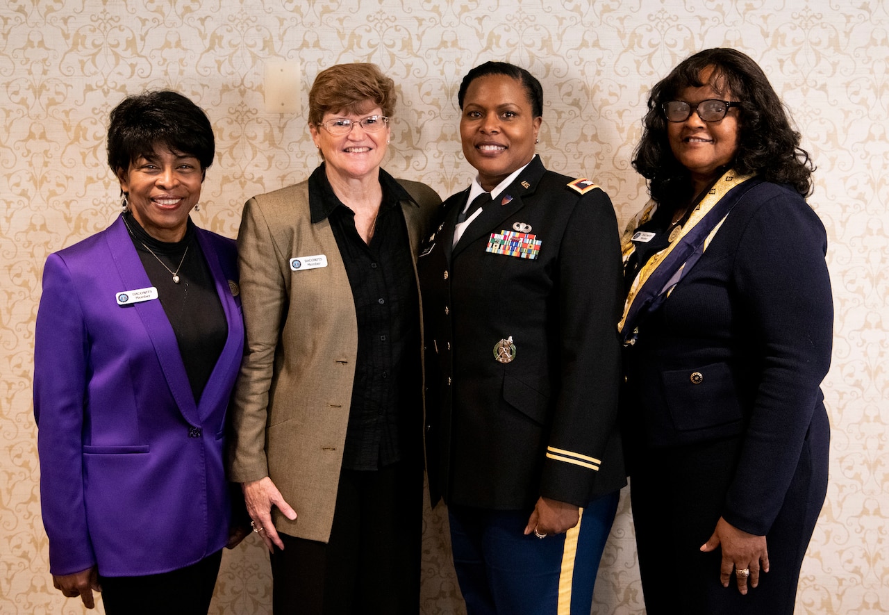 Four women pose for a photo.