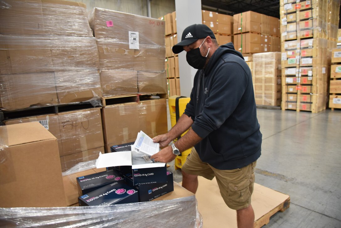 man checks list of packing materials