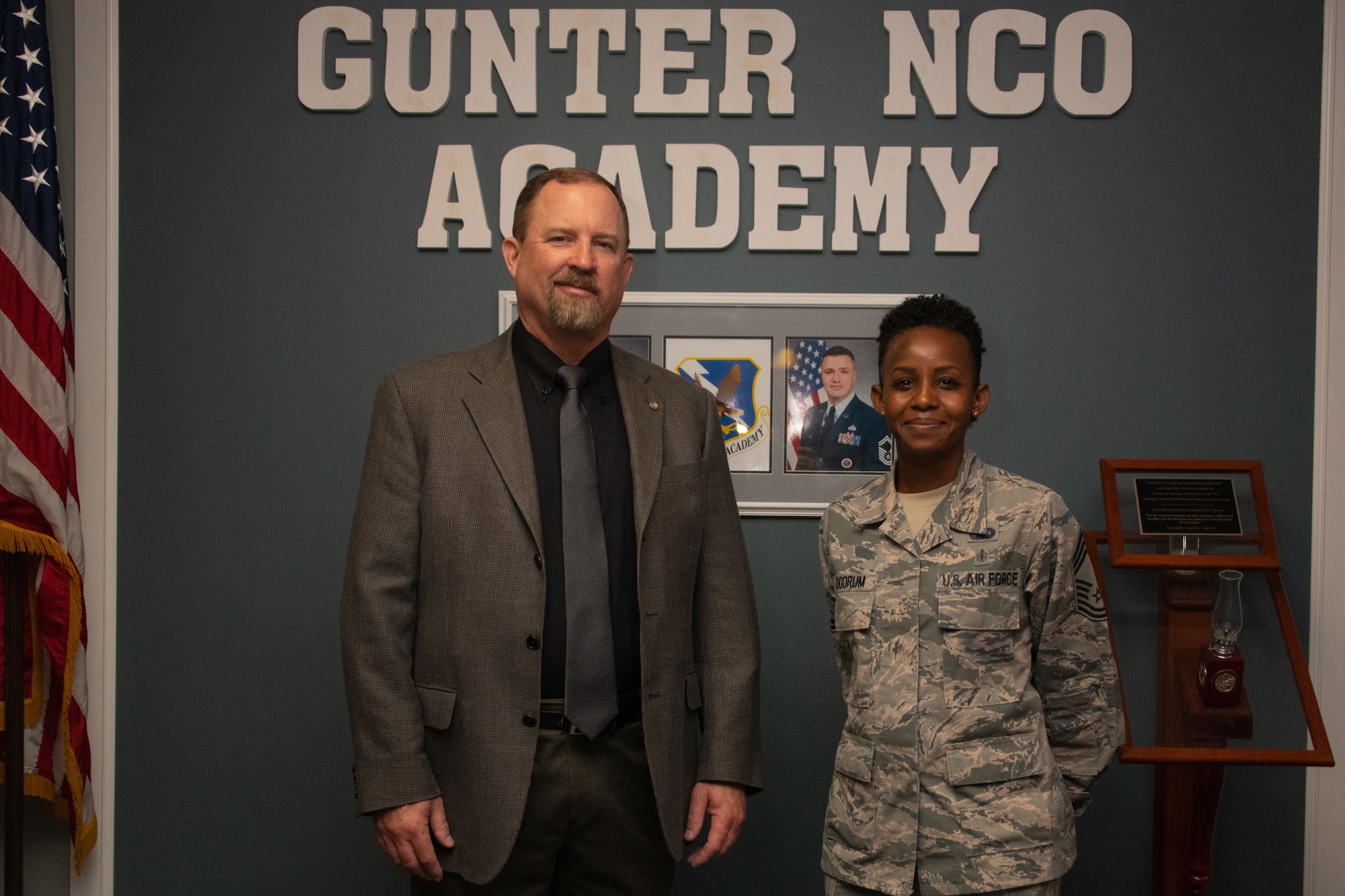 Toxie Robbins, former Gunter Noncommissioned Officer Academy commandant, poses for a photo beside Chief Master Sgt. Rosita Goodrum, the new commandant of Gunter NCOA