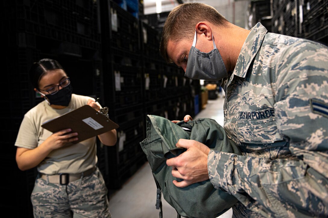 A photo of an Airman reading a serial number