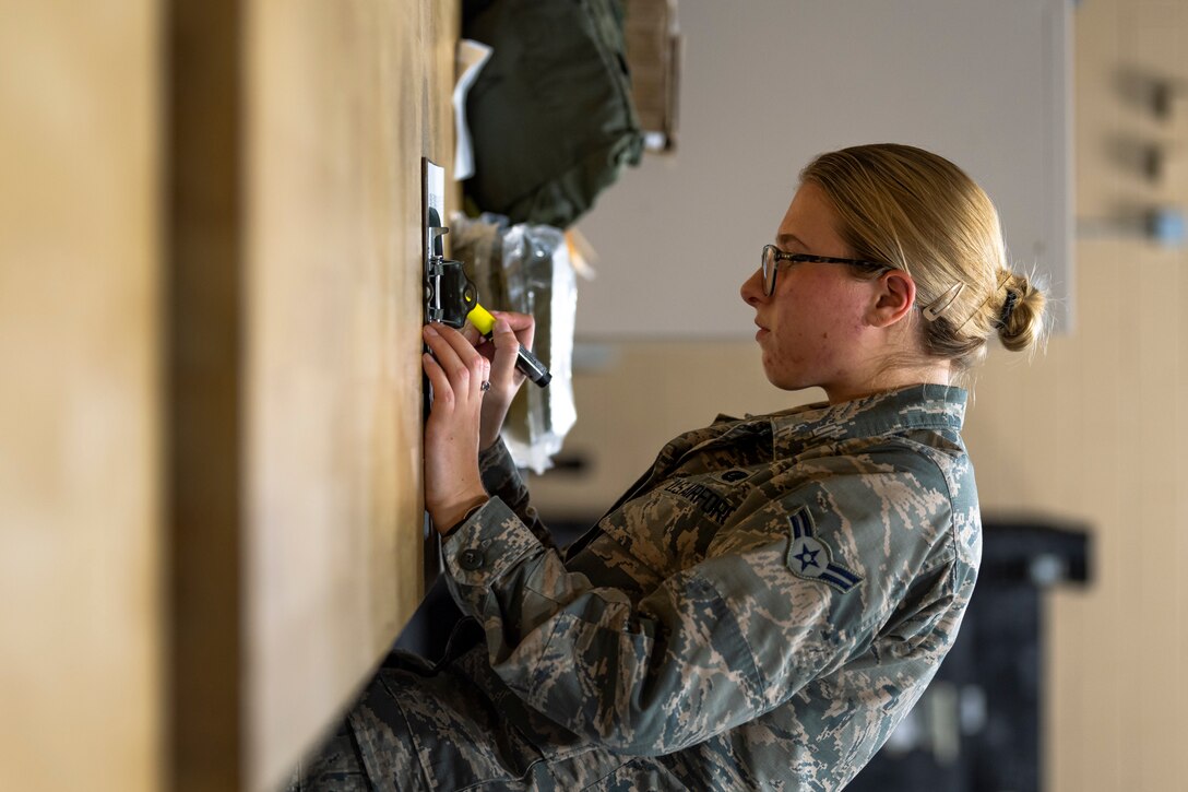 A photo of an Airman using a highlighter on a form