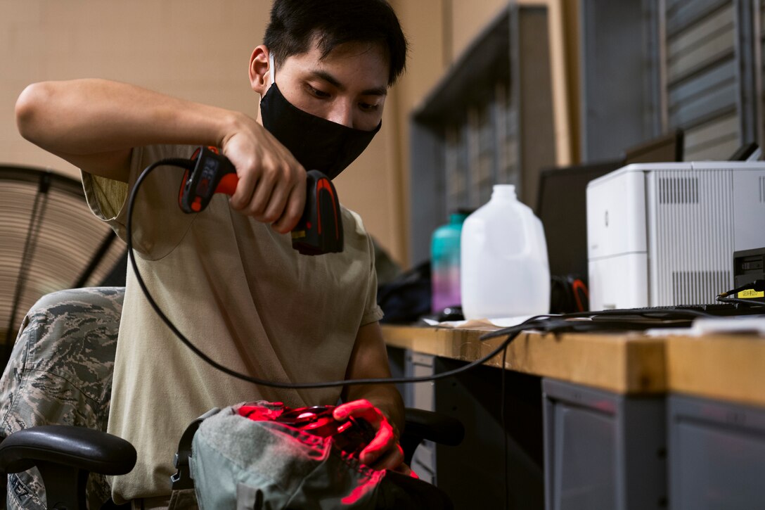 A photo of an Airman scanning a barcode