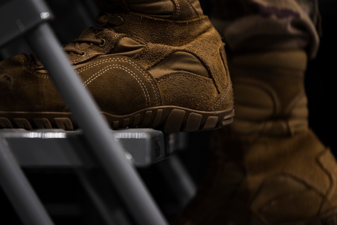 A photo of an Airman using a ladder