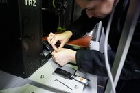 Fireman Apprentice Cynthia Fang receives training on how to replace the build plate on a Lulzbot Taz 6 printer aboard USS Dwight D Eisenhower (CVN 69). Naval Surface Warfare Center, Philadelphia Division and Carderock Division engineers have continued to support current Additive Manufacturing (AM) trials on different ship classes.