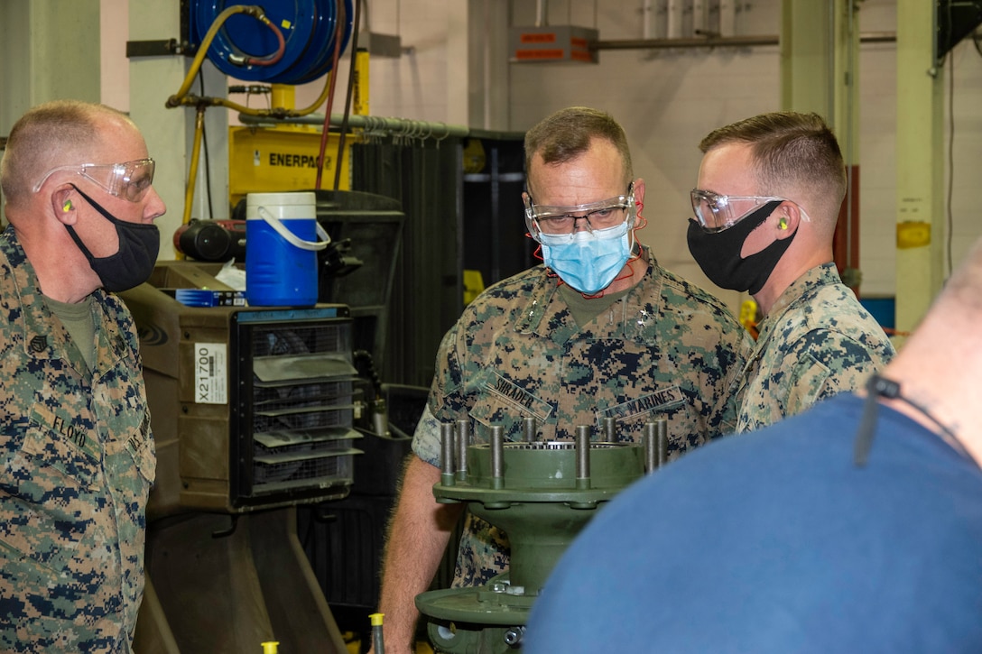 (Left) Staff Sergeant Todd Floyd, Maintenance Chief, and Cpl. Shawn Downey, 3rd Light Armored Recconnaisance Battalion, Marine Corps Air Ground Combat Center, 29 Palms, Calif., talk with Maj. Gen. Joseph F. Shrader, MARCORLOGCOM commanding general, during his visit to Production Plant Barstow, Marine Depot Maintenance Command aboard the Yermo Annex of Marine Corps Logistics Base Barstow, Sept. 29.