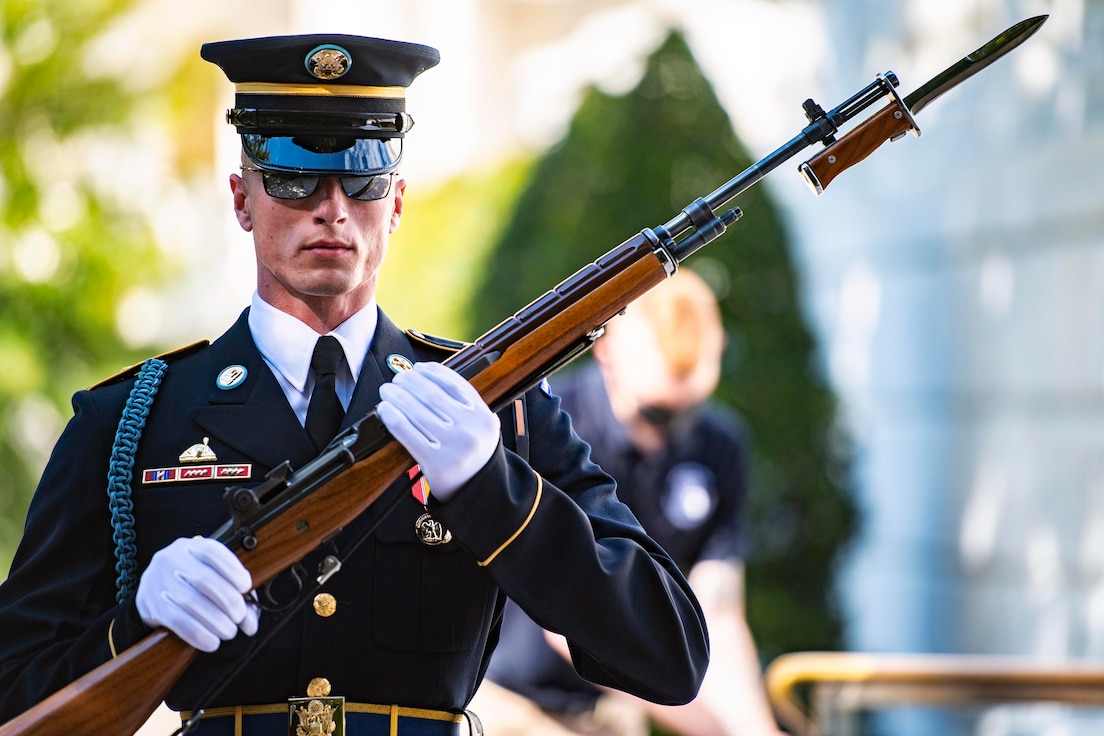 A soldier holds a weapon.