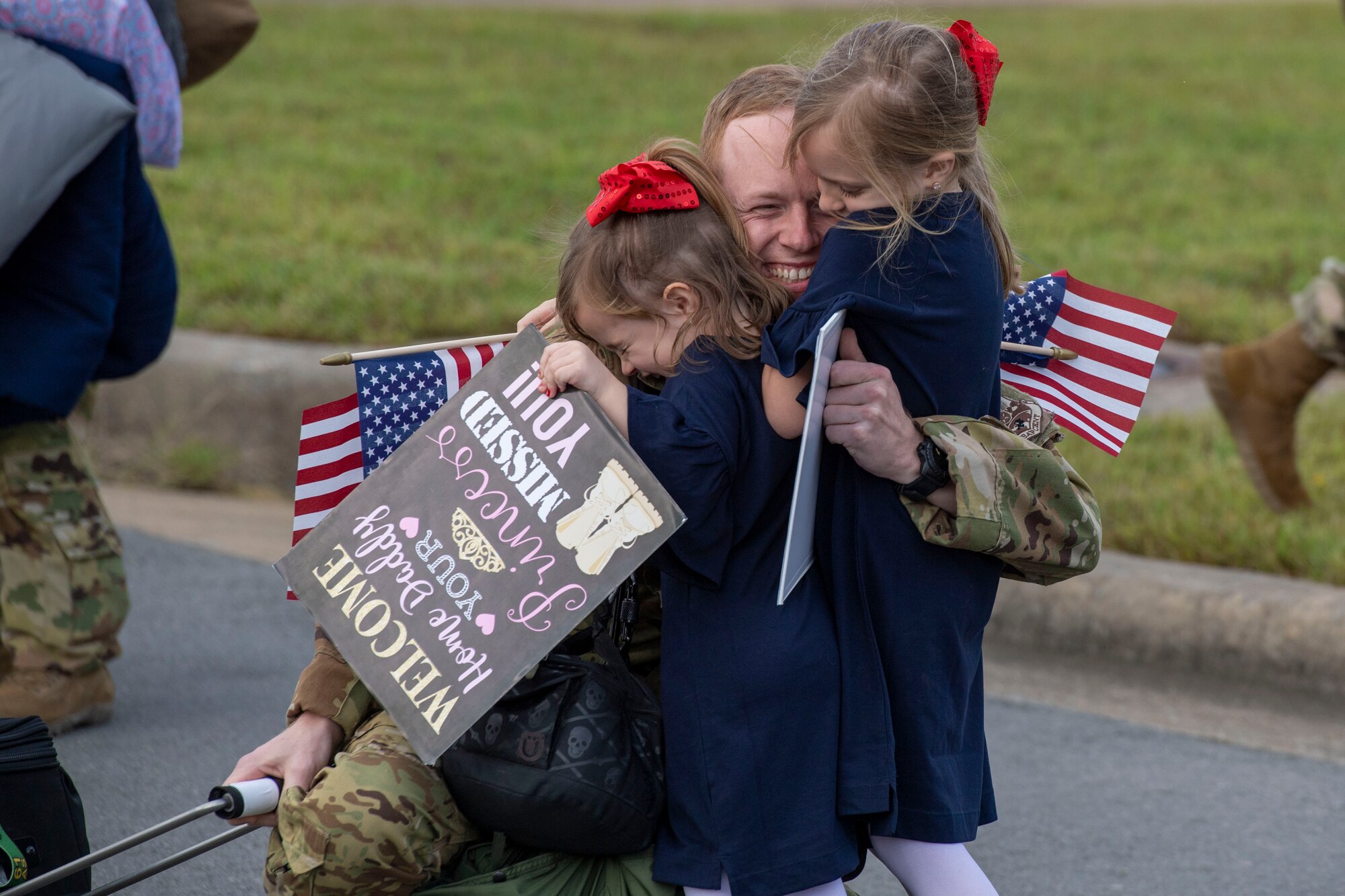 An Airman greets his family upon returning from a deployment.