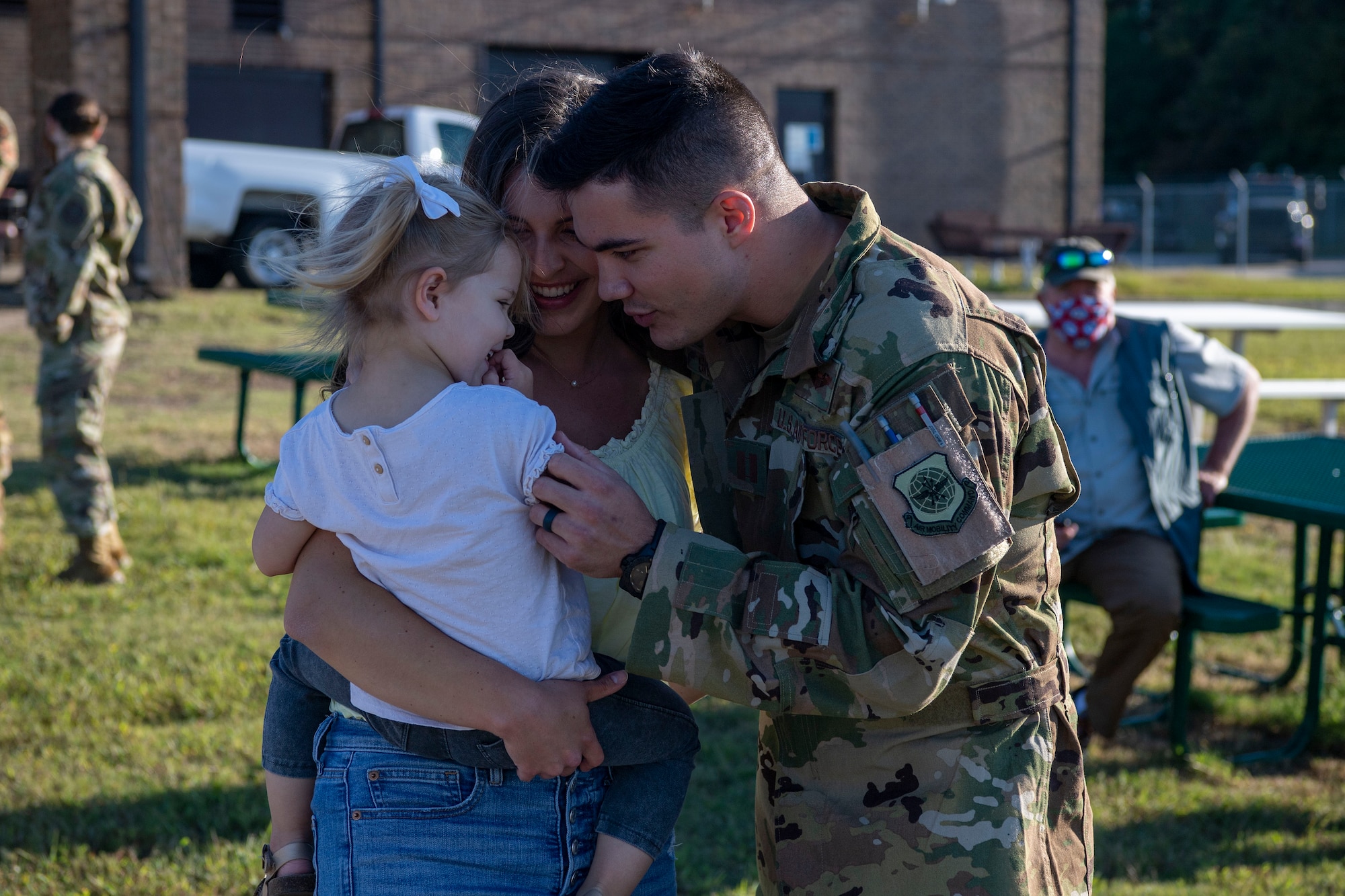 An Airman reunites with his family upon returning from a deployment.
