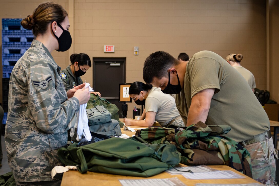 A photo of Airmen signing in equipment