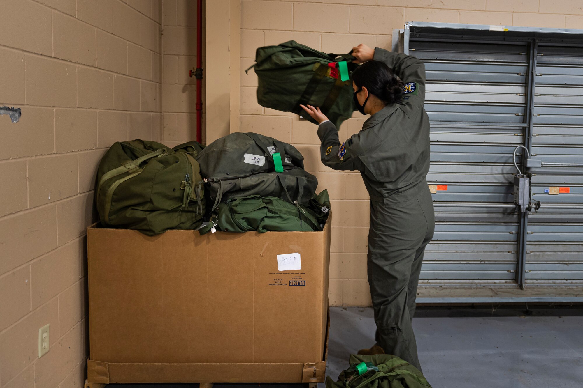 A photo of a customer placing a gear bag into a box