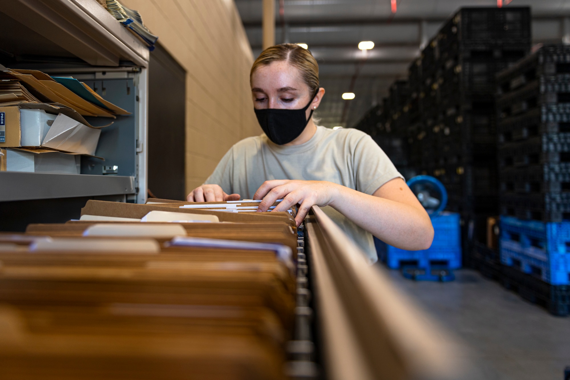 A photo of an Airman looking for an Air Force form