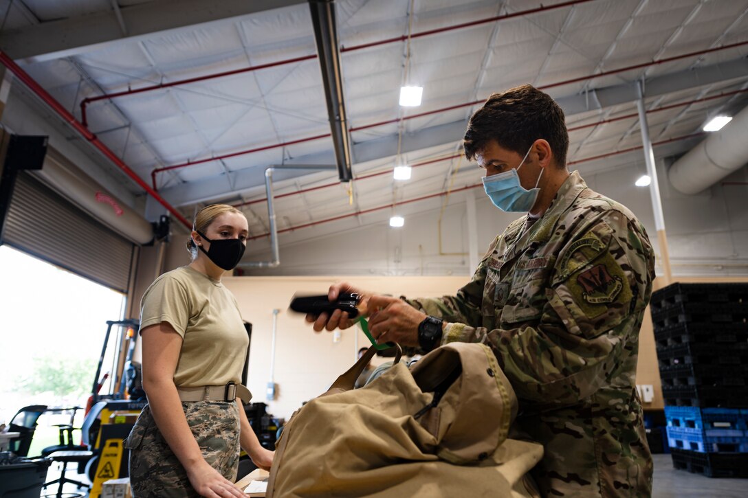 A photo of a customer stapling a tag to an IPE bag