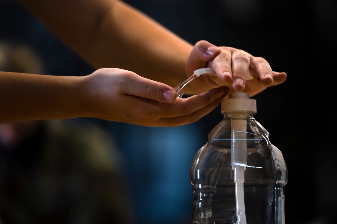 A photo of an Airman using hand sanitizer