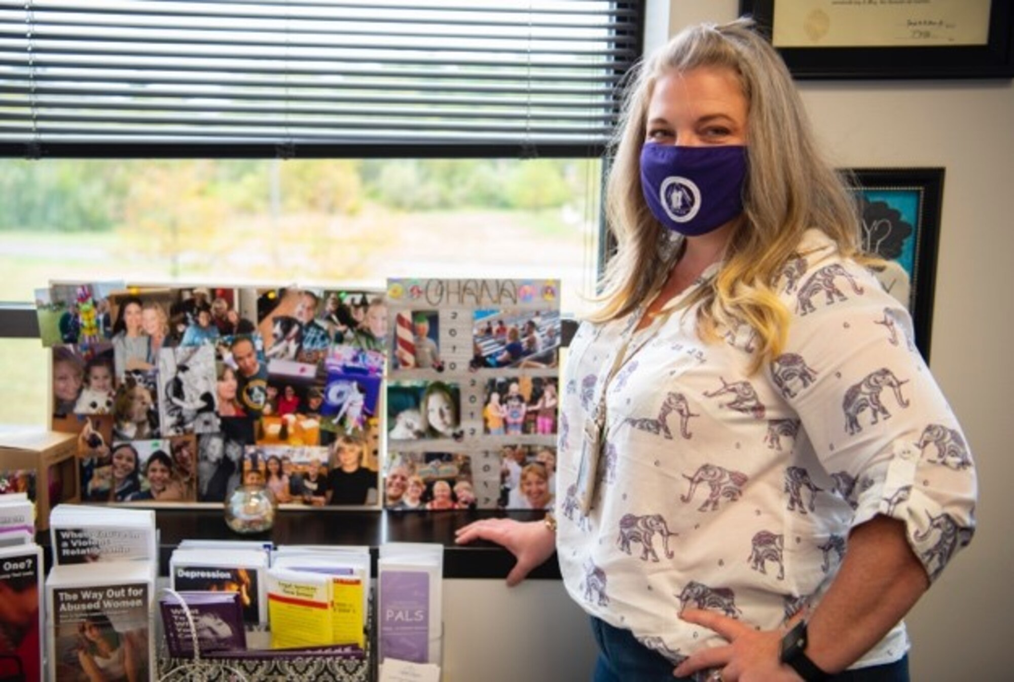 A person poses in her office.