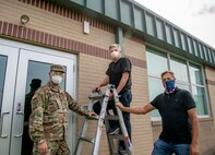 James Blair, an IT Technician with Tate Communications, poses with Staff Sgt. Douglas Cooper and Steve Labelle, Telecommunications Specialists with the West Virginia National Guard, during the instillation of an outdoor WiFi booster on the Summersville Armory, September 15, 2020. The WiFi booster will allow students and parents to access free WiFi internet at WVNG armories at multiple locations around the state in support of Governor Jim Justice’s Kids Connect Initiative. The initiative is part of a statewide response effort to the COVID-19 pandemic and will provide internet access and availability at public spaces to students throughout areas of West Virginia where reliable internet is not always available. (U.S. Army National Guard photo by Edwin L. Wriston)