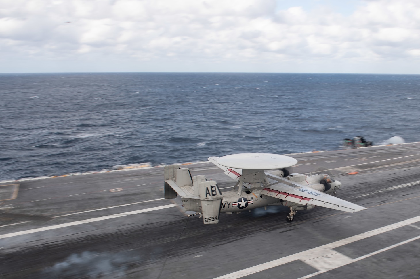 An E-2C Hawkeye, assigned to Carrier Airborne Early Warning Squadron (VAW) 126, lands on the flight deck of the aircraft carrier USS John C. Stennis (CVN 74).
