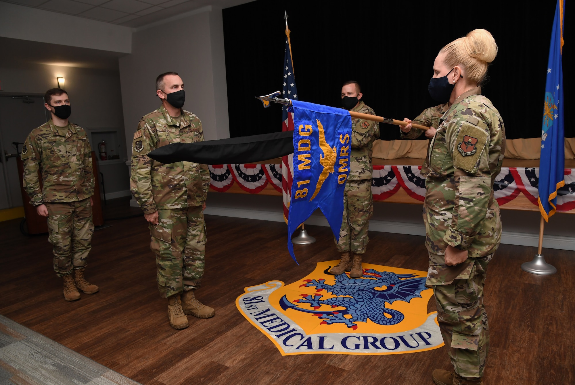 The 81st Operational Medical Readiness Squadron guidon is unfurled during a redesignation ceremony inside the Keesler Medical Center at Keesler Air Force Base, Mississippi, September 30, 2020. In an effort to meet Department of Defense policy to increase operational medical readiness and duty availability for active duty personnel, while continuing to ensure the delivery of high quality health care, the 81st OMRS replaced the 81st Aerospace Medicine Squadron. (U.S. Air Force photo by Kemberly Groue)