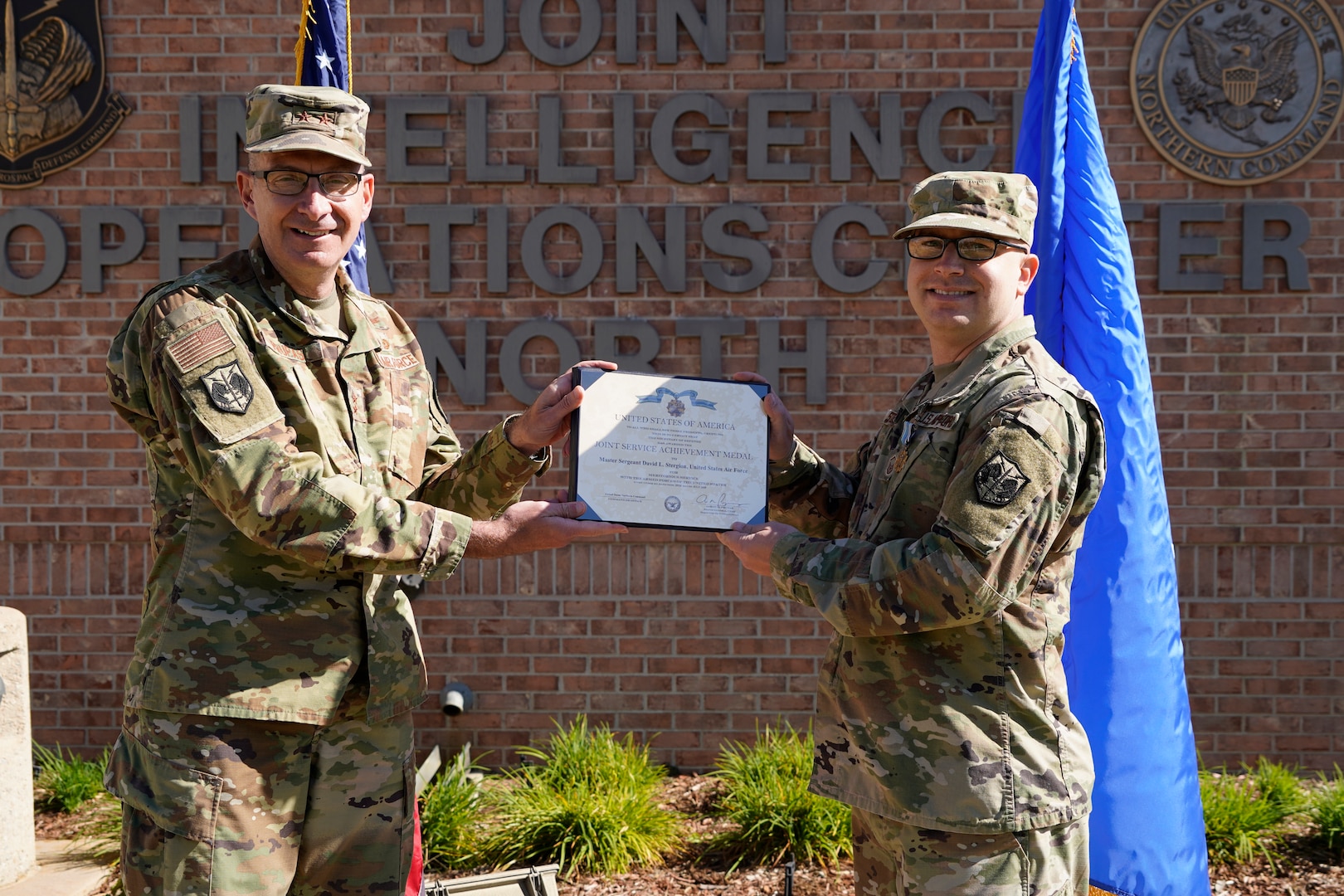 U.S. Air Force Maj. Gen. Aaron Prupas, North American Aerospace Defense Command and U.S. Northern Command Director of Intelligence, presents the Joint Service Achievement Medal to Master Sgt. David Stergion Jr., NORAD and USNORTHCOM NCO-in-charge of Intelligence Plans and Exercises, Sept 28, 2020, for his heroic actions on the night of Feb. 14, 2020. Sergeant Stergion demonstrated outstanding judgment and selflessness as the first person to respond to the scene of a serious car accident near Estes Park, Colorado, Feb. 14, 2020.