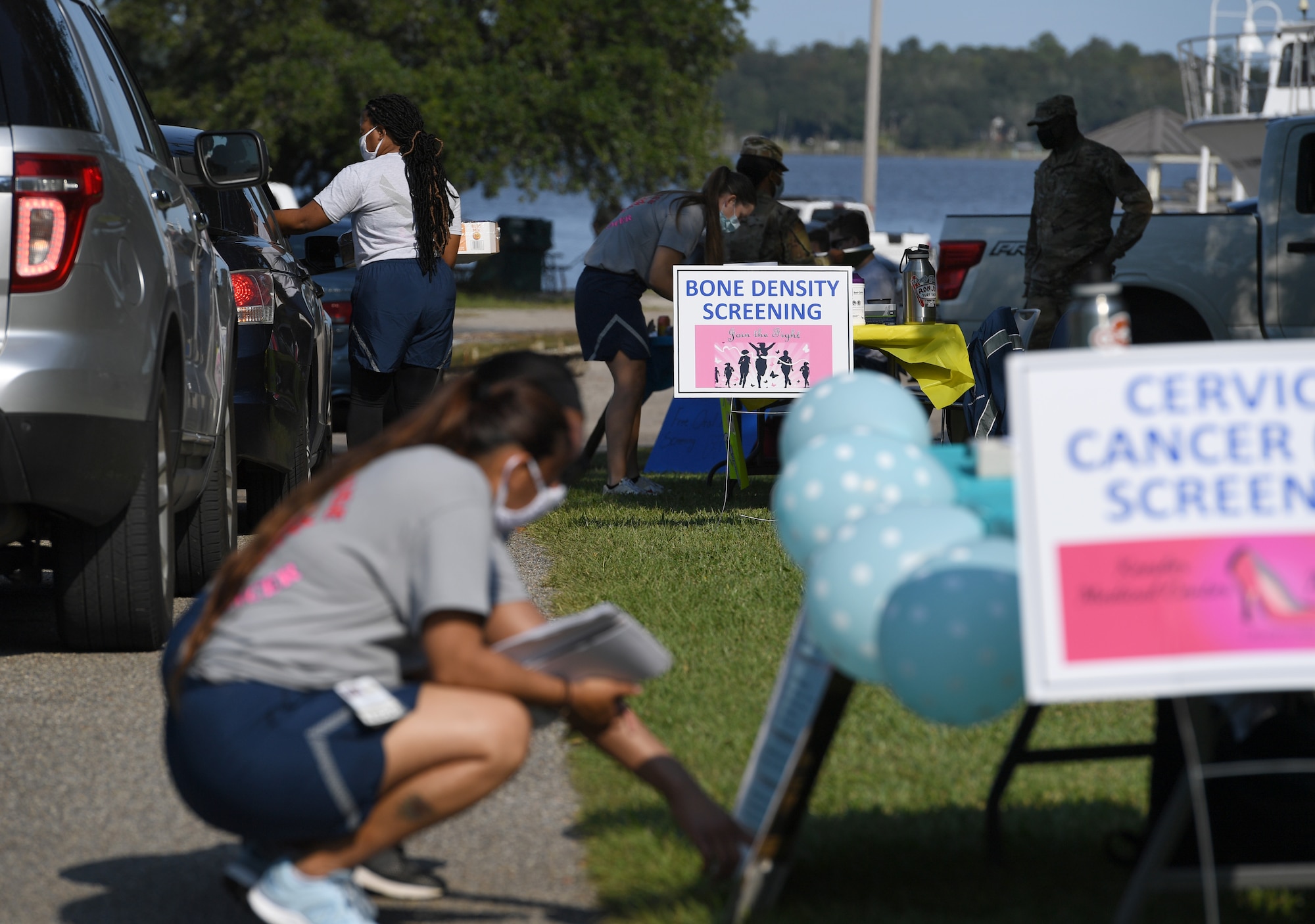 Members of the 81st Medical Group assist attendess during the 81st MDG Drive-Through Health Expo at the Marina at Keesler Air Force Base, Mississippi, October 2, 2020. The 81st MDG hosted the drive-through event, which included scheduling appointments for mammograms and multiple types of cancer and chronic diseases in honor of Breast Cancer Awareness Month. (U.S. Air Force photo by Kemberly Groue)