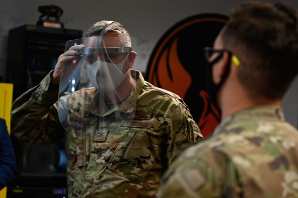 Airman holds 3D-printed award