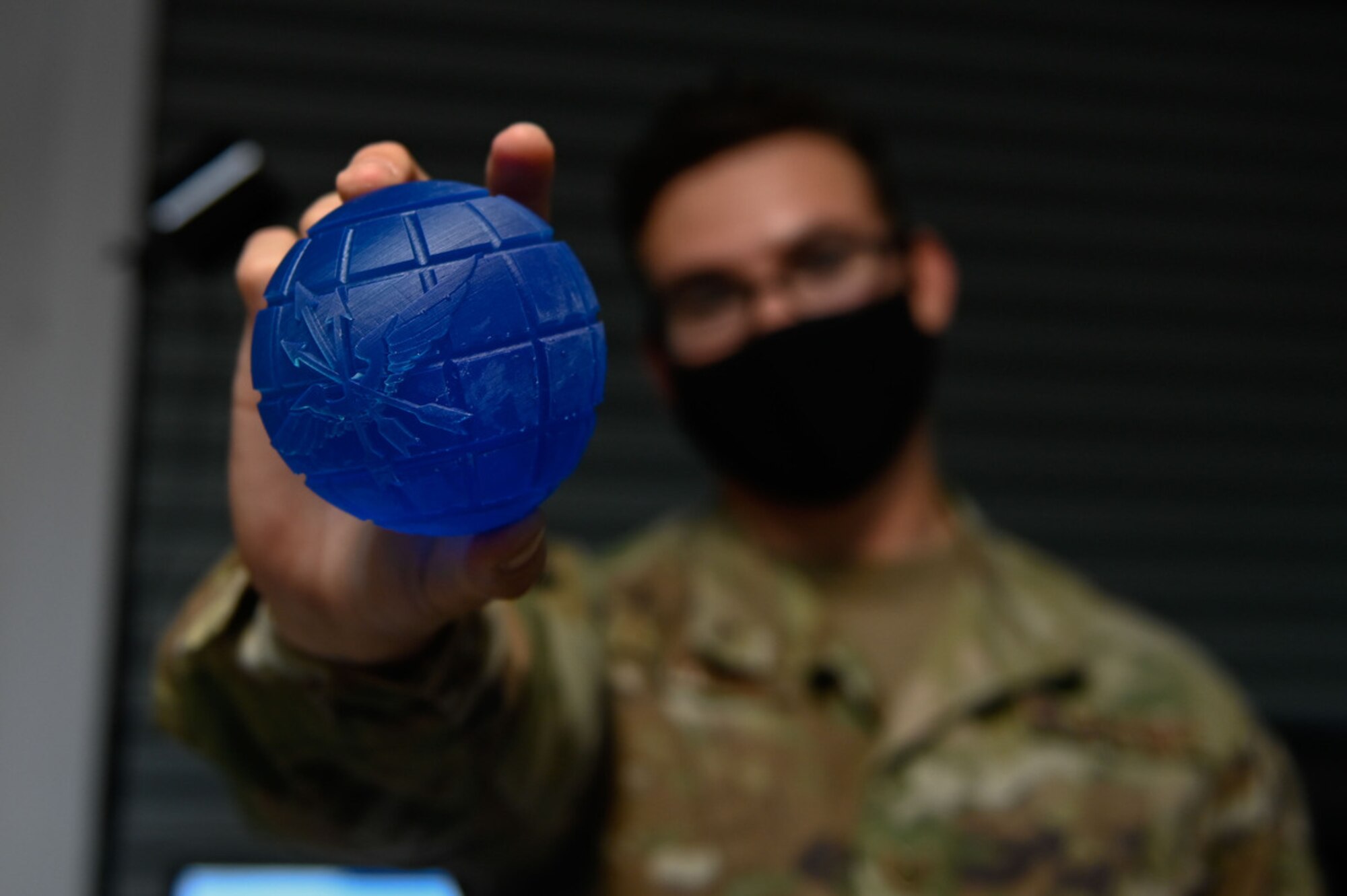 Airman holds 3D-printed award