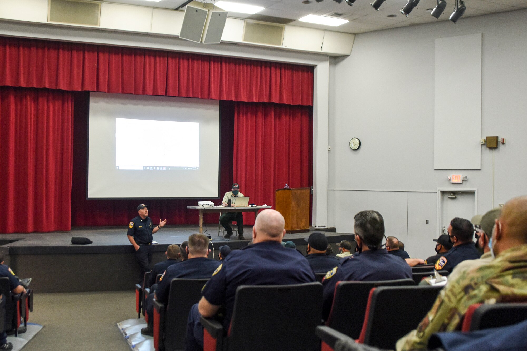 Members from Cal Fire, the National Forestry Service, the California National Guard, the Fresno Country Sheriff's Department, and other response organizations meet, Sept. 6, 2020, at Sierra High School in Tollhouse, Calif. which was used as the Creek Fire Emergency Operations Center and Incident Command Post.