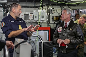 The Honorable Kenneth Braithwaite, Secretary of the Navy, receives an update from Commodore Steve Moorhouse, Commander United Kingdom Carrier Strike Group, while visiting Her Majesty's Ship Queen Elizabeth at sea off the coast of Flamborough, United Kingdom.