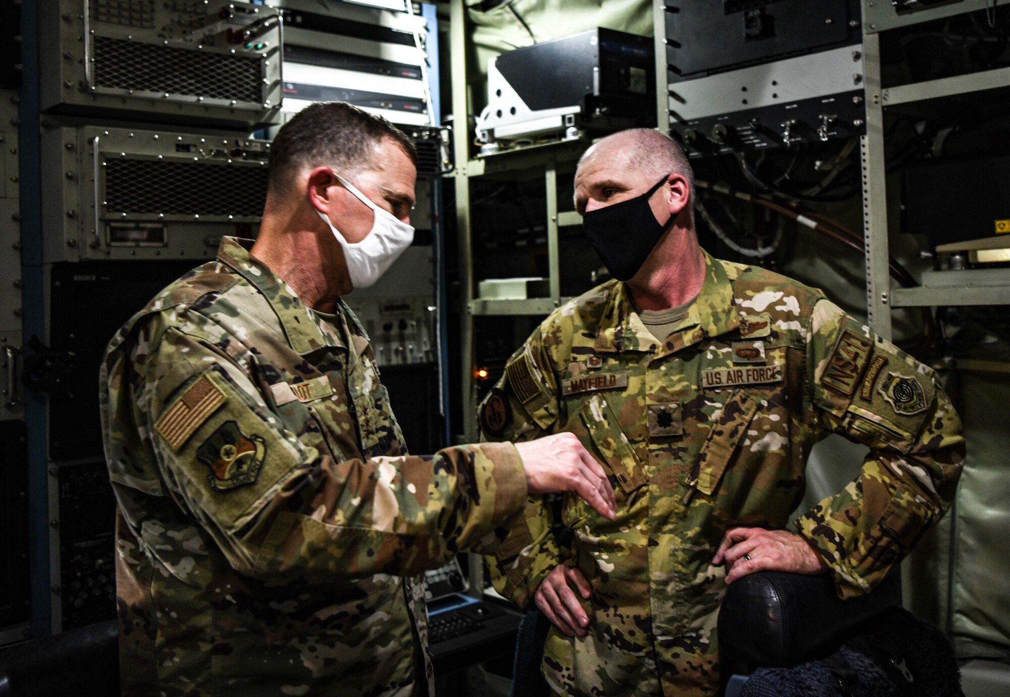 U.S. Air Force Lt. Gen. Greg Guillot, U.S. Air Forces Central commander, talks with Lt. Col. Jeremy Mayfield, 41st Expeditionary Electronic Combat Squadron commander, during a tour inside an EC-130H Compass Call aircraft, Sept. 27, 2020, at Al Dhafra Air Base, United Arab Emirates.