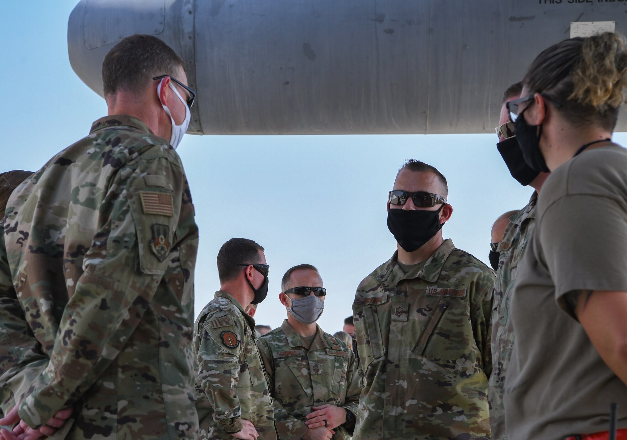 U.S. Air Force Lt. Gen. Greg Guillot, U.S. Air Forces Central commander, and U.S.  Air Force Chief Master Sgt. John Storms, USAFCENT command chief, speak with Airmen at the 380th Air Expeditionary Wing at Al Dhafra Air Base, United Arab Emirates, Sept. 27, 2020.
