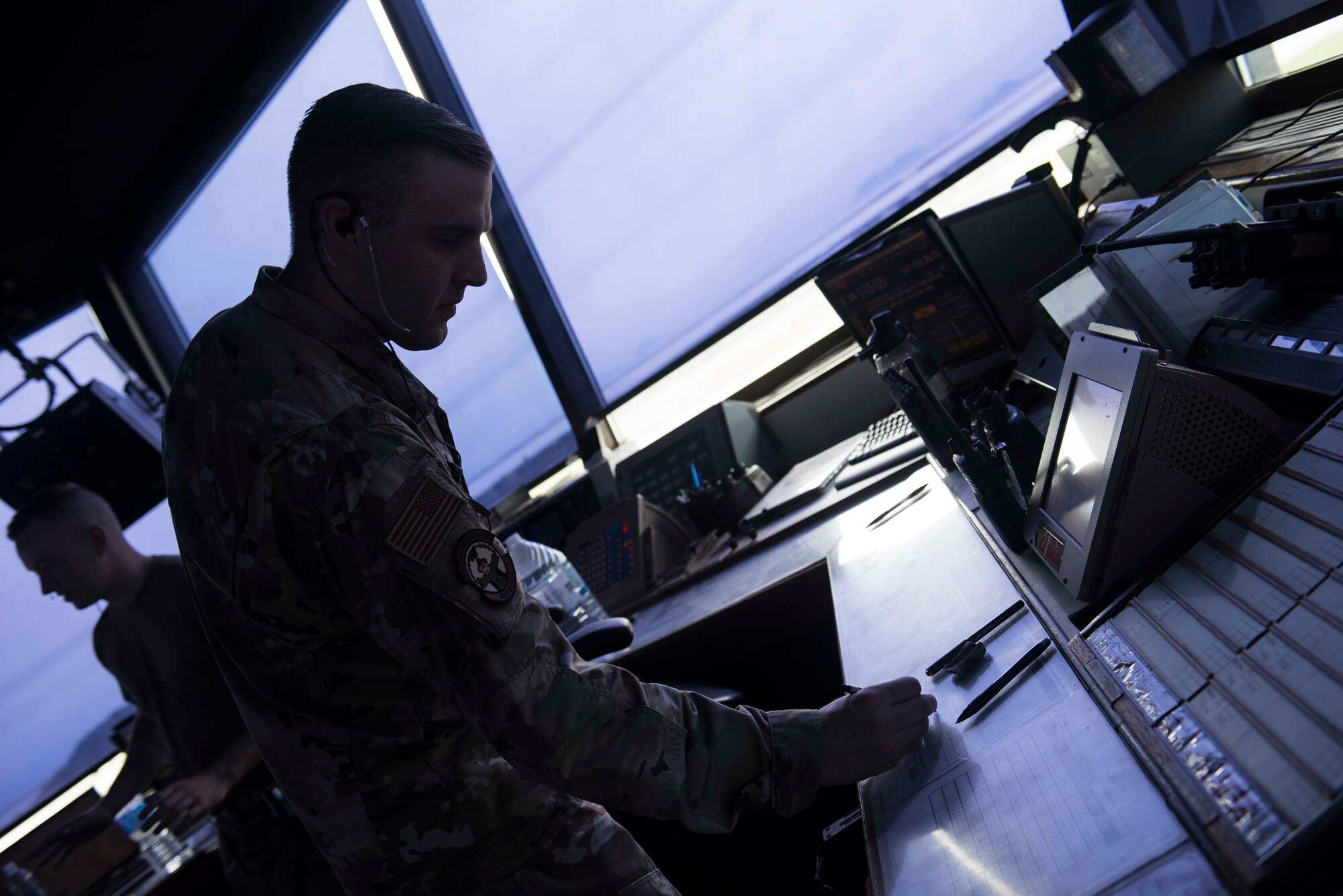 A photo of an Airman writing down information