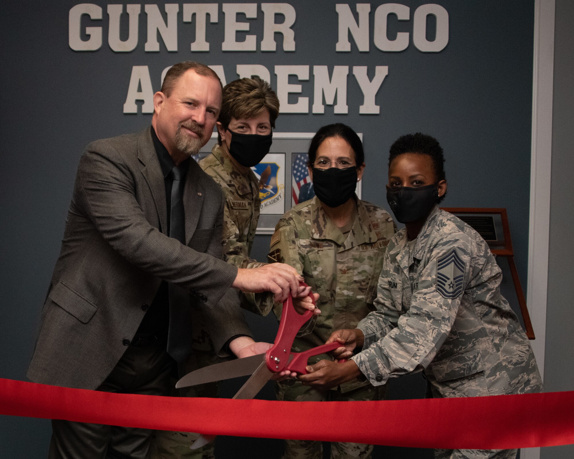 Gunter NCOA staff cut the ribbon leading to the new Gunter NCOA