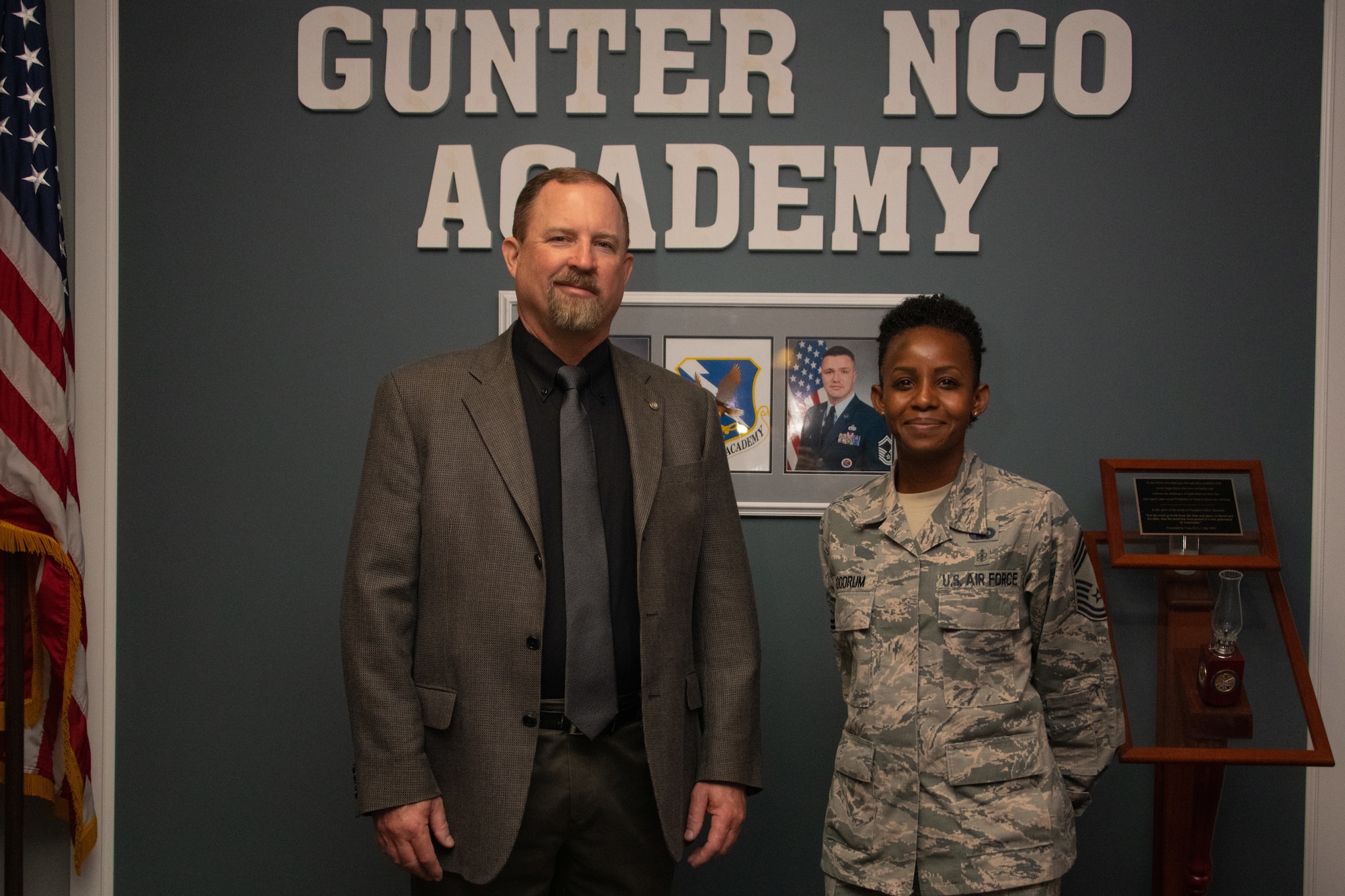 Toxie Robbins, former Gunter Noncommissioned Officer Academy commandant, poses for a photo beside Chief Master Sgt. Rosita Goodrum, the new commandant of Gunter NCOA