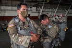 Soldiers prepare to parachute.