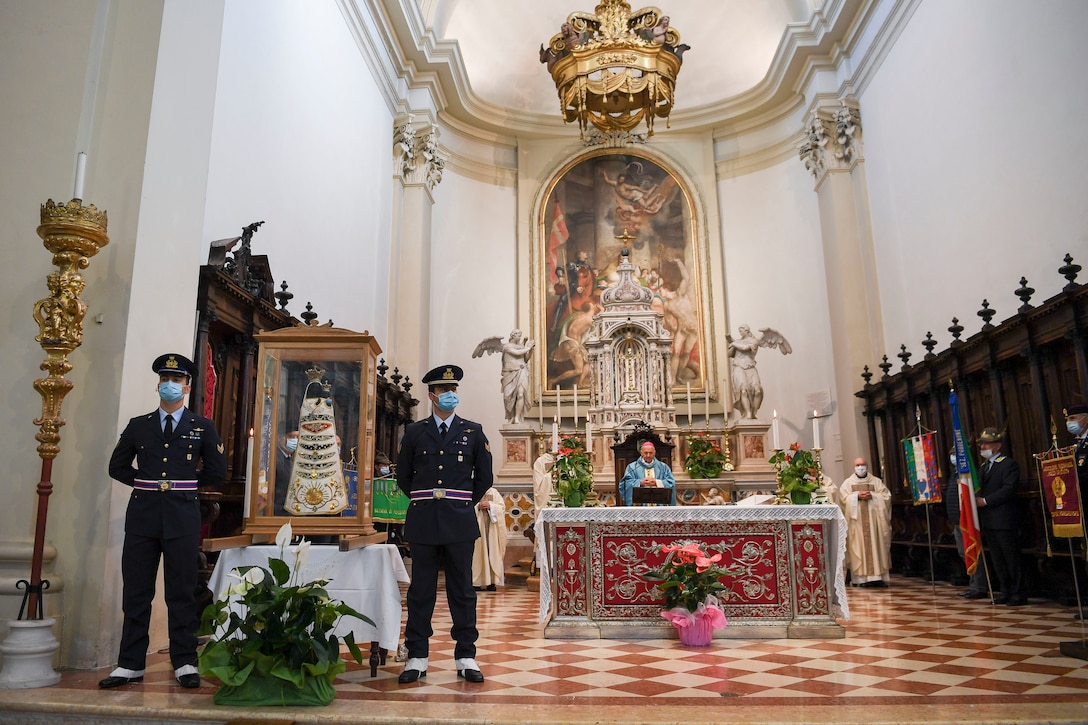 Two Italian air force members stand guard by a Madonna Di Loreto statue during holy mass in Pordenone, Italy, Sept. 29, 2020. The Madonna Di Loreto is the Patroness of Aeronauts, as declared by Pope Benedict XV. (U.S. Air Force photo by Staff Sgt. Savannah L. Waters)