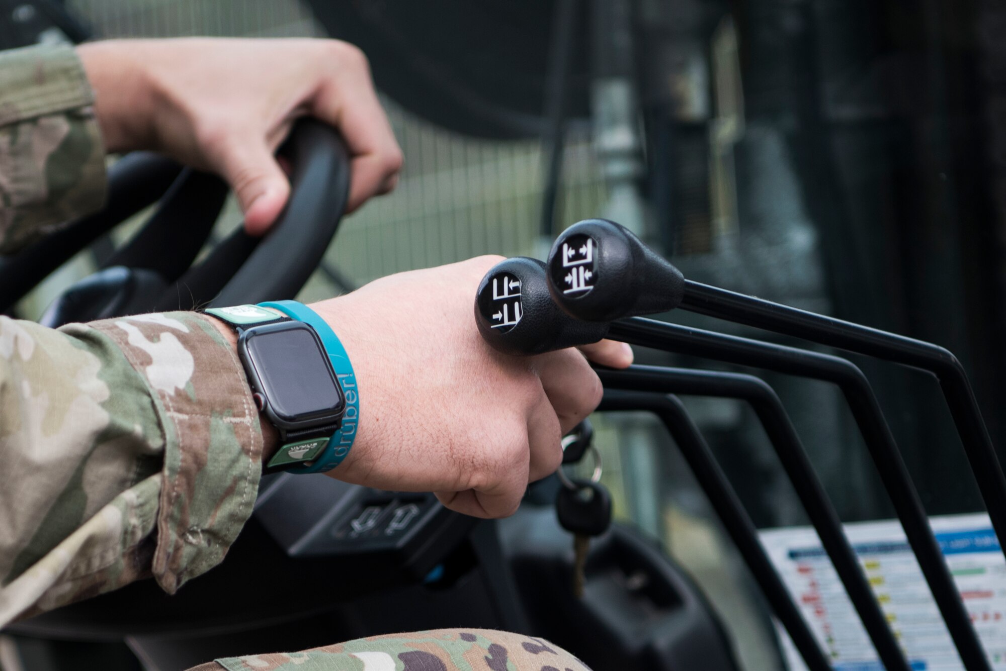 A U.S. Airman assigned to the 721st Aircraft Maintenance Squadron shifts the controls of a 10k forklift during a multi-capable Airmen lift-and-shift training.