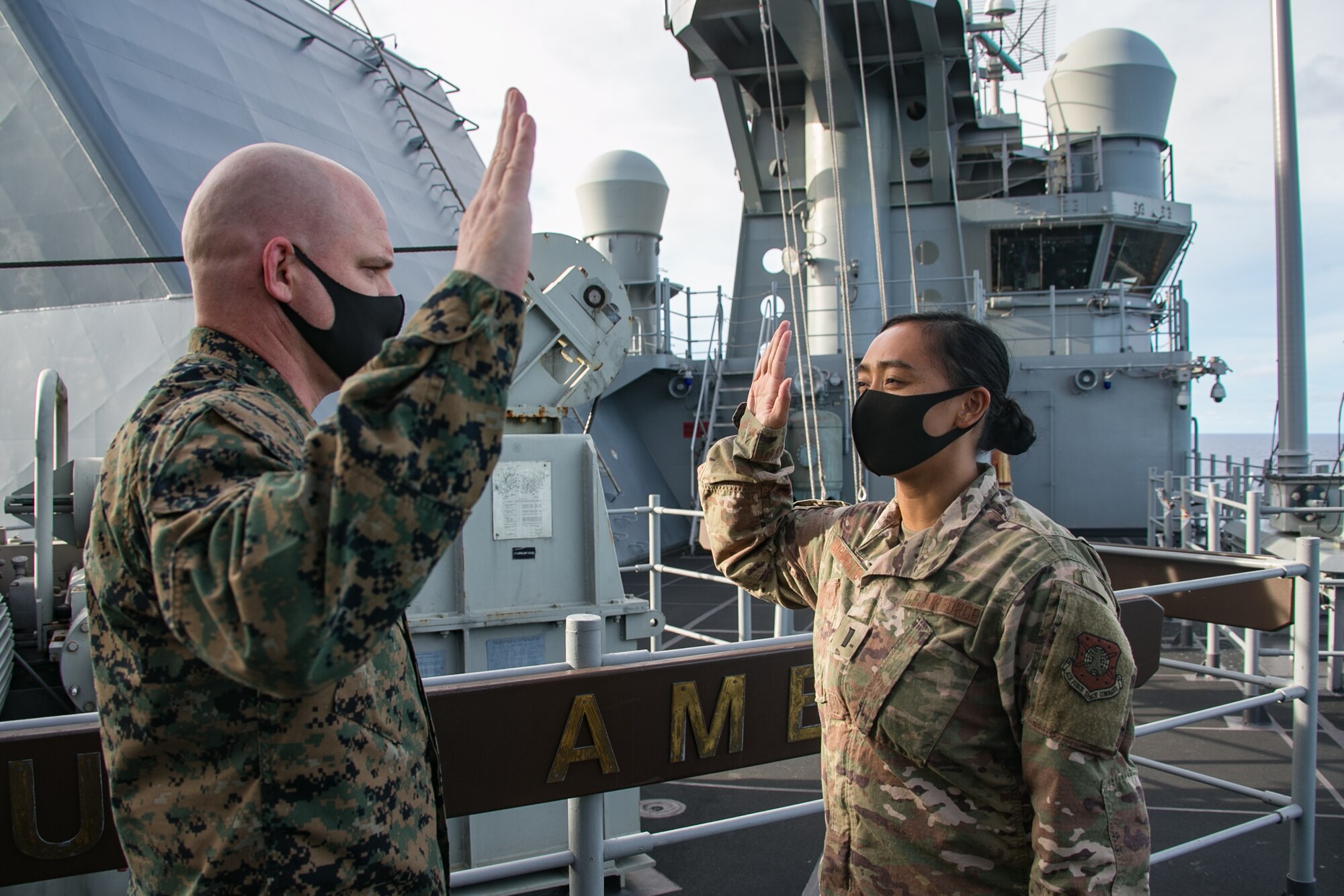 PHILIPPINE SEA (Sept. 17, 2020) 1st Lt. Rio Sarmiento, assigned to the 16th Space Control Squadron (SPCS), was administered the oath of office into the United States Space Force by U.S. Marine Col. Michael Nakonieczny, commanding officer of the 31st MEU, aboard amphibious assault ship USS America (LHA 6). Sarmiento was transferred from being an Air Force Space Operations Officer to becoming the first Space Force Liaison Officer (LNO) deployed with the 31st MEU. America, flagship of the America Expeditionary Strike Group, 31st MEU team, is operating in the U.S. 7th fleet area of operations to enhance interoperability with allies and partners and serve as a ready response force to defend peace and stability in the Indo-Pacific region. (U.S. Marine Corps photo by Lance Cpl. Brienna Tuck)