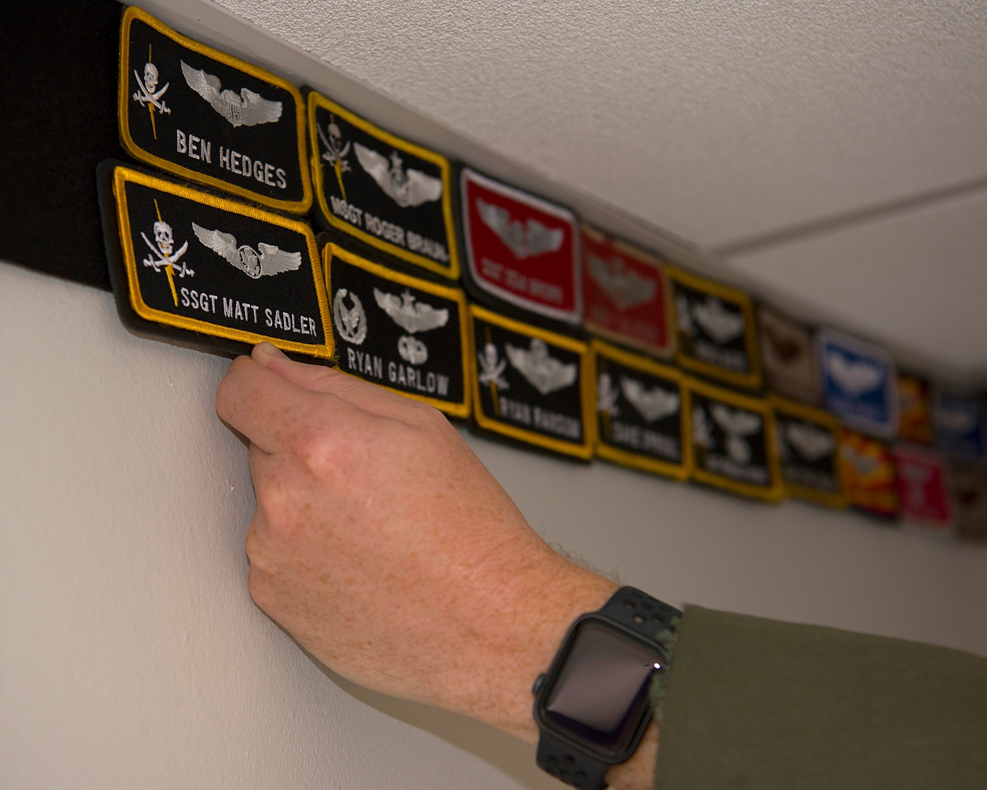 U.S. Air Force Maj. Douglas Karl, the 91st Air Refueling Squadron assistant director of operations, puts a patch up in the 91st ARS heritage room at MacDill Air Force Base, Sept. 29, 2020.