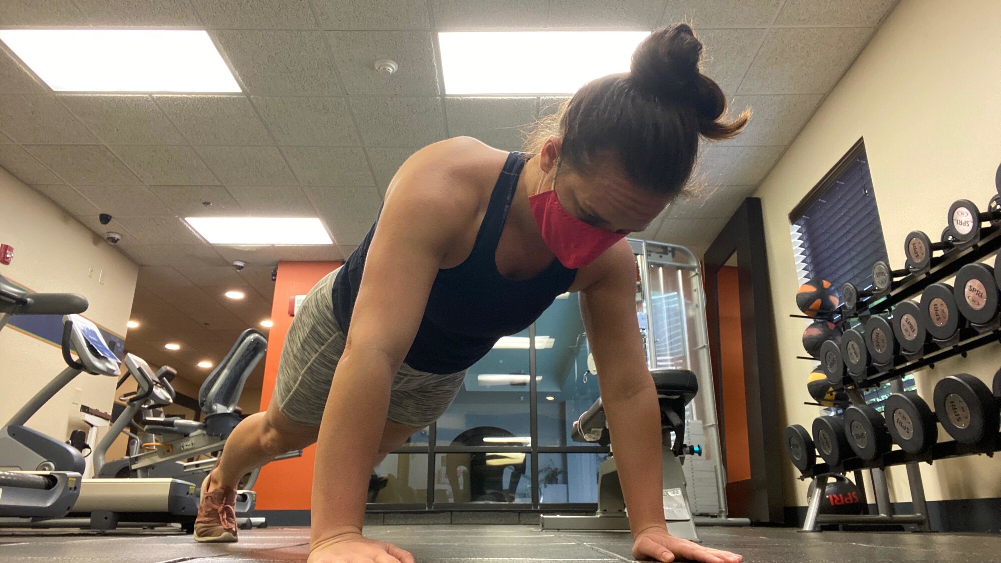 Senior Airman Micah Coate, 452nd Air Mobility Wing Public Affairs specialist, holds the push-up portion for her mock Air Force Physical Training Test while on Temporary Duty at Robins Air Force Base, Georgia.