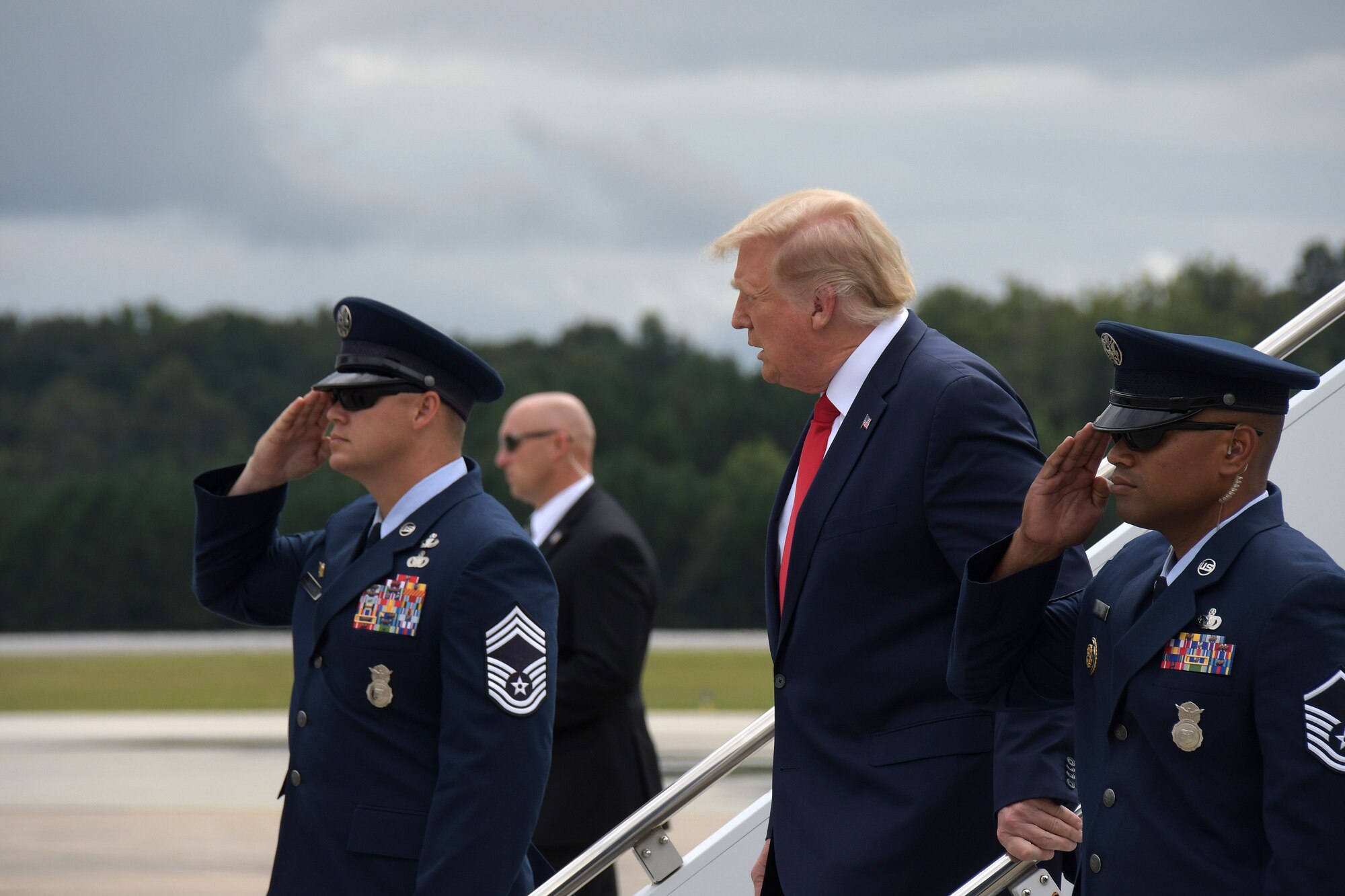 Air Force One aircrew members salute President Trump as he departs Air Force One at Dobbins Air Reserve Base, Ga., Sept. 25, 2020. The president arrived at Dobbins to attend a meeting at the Cobb Galleria. (U.S. Air Force photo/Andrew Park)