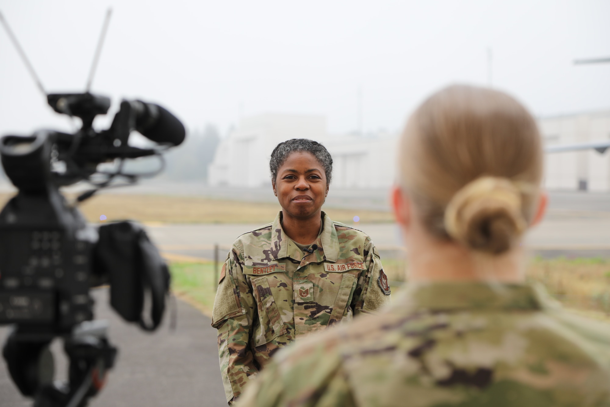 A Reserve Citizen Airman films a thank you video to her civilian employer on the flight line.