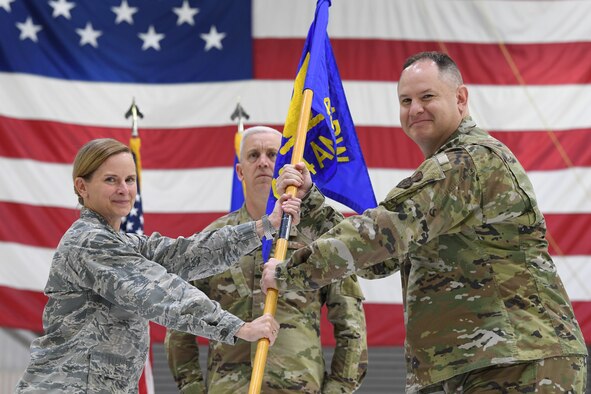 Maj. Matthew Dickerson, 434th Aircraft Maintenance Squadron commander, symbolically accepts a guidon from Col. Arianne Mayberry, 434th Maintenance Group commander, during a change of command ceremony at Grissom Air Reserve Base, Oct. 4, 2020. Dickerson moved into the role after three years as commander of the 434th Maintenance Operations Section.